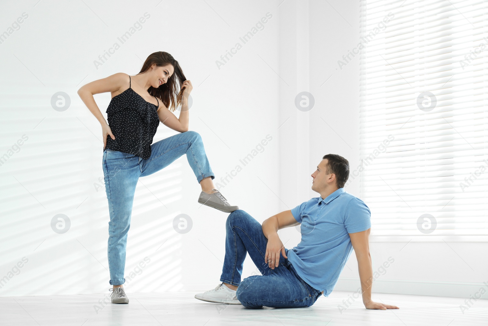 Photo of Happy young couple dancing in empty studio