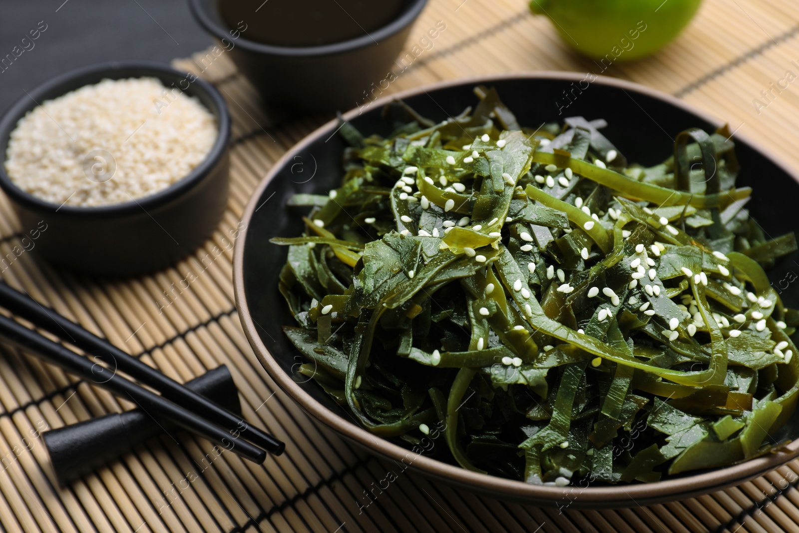 Photo of Fresh laminaria (kelp) seaweed served on table, closeup