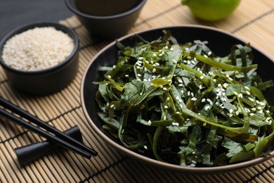 Photo of Fresh laminaria (kelp) seaweed served on table, closeup