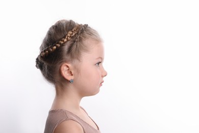 Photo of Little girl with braided hair on white background. Space for text