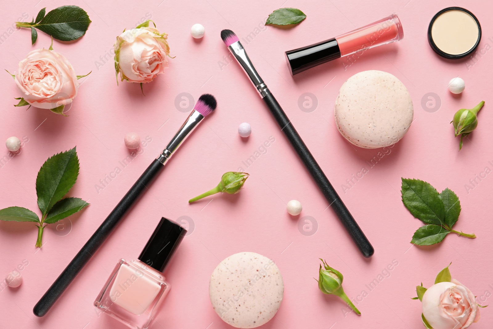 Photo of Flat lay composition with products for decorative makeup on pastel pink background