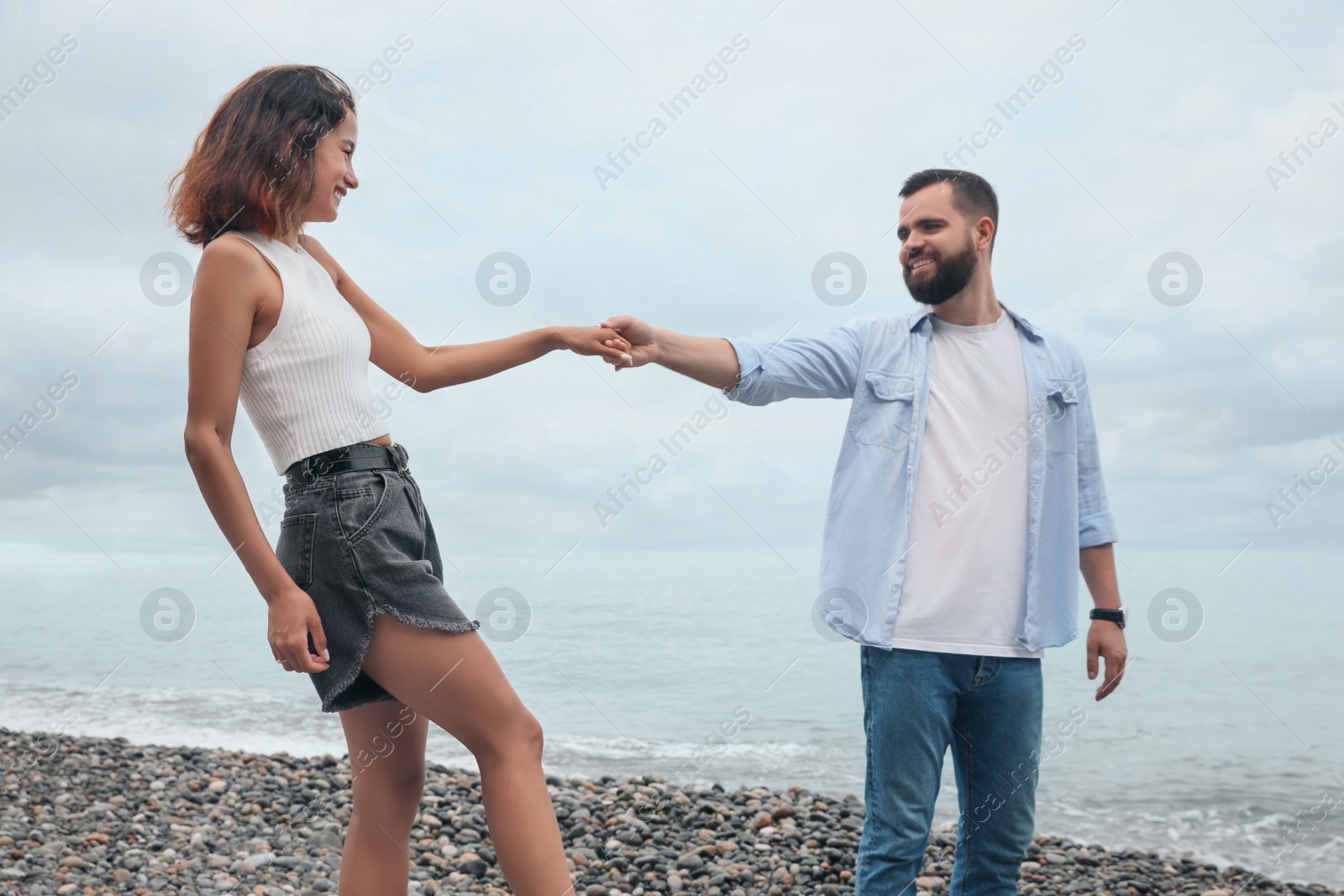 Photo of Happy young couple on beach near sea