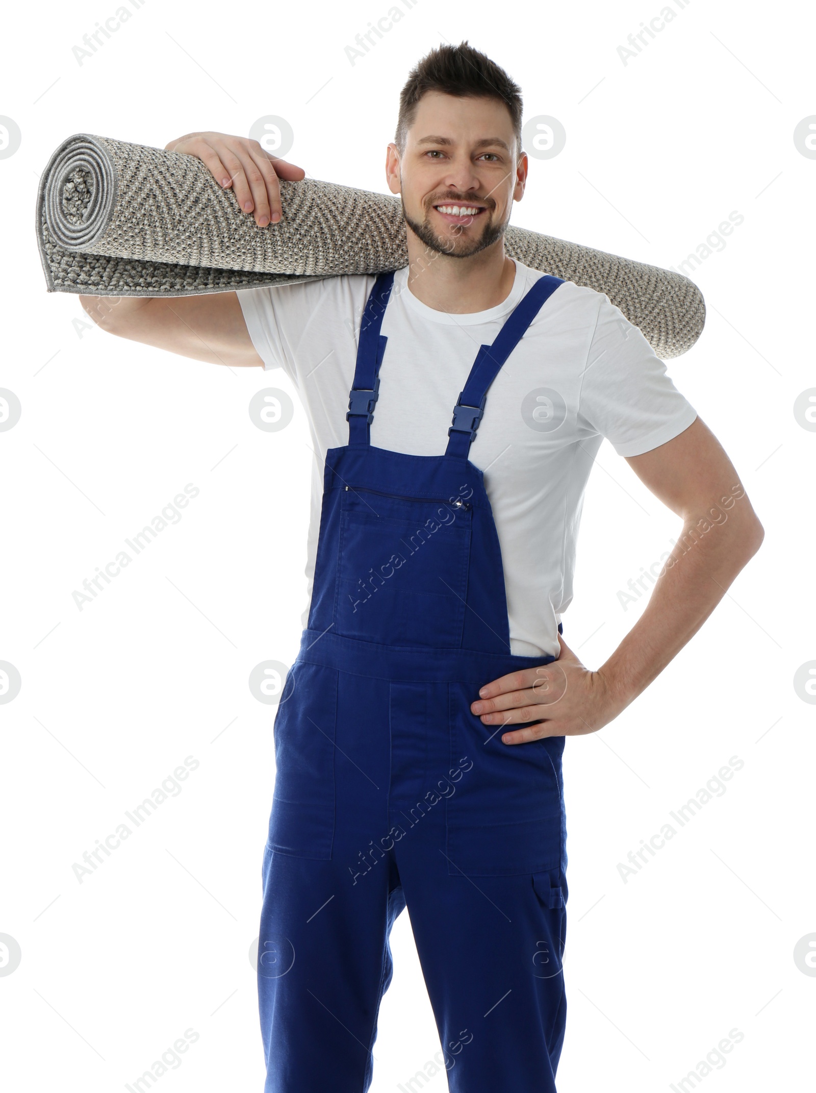 Photo of Male worker with rolled carpet on white background