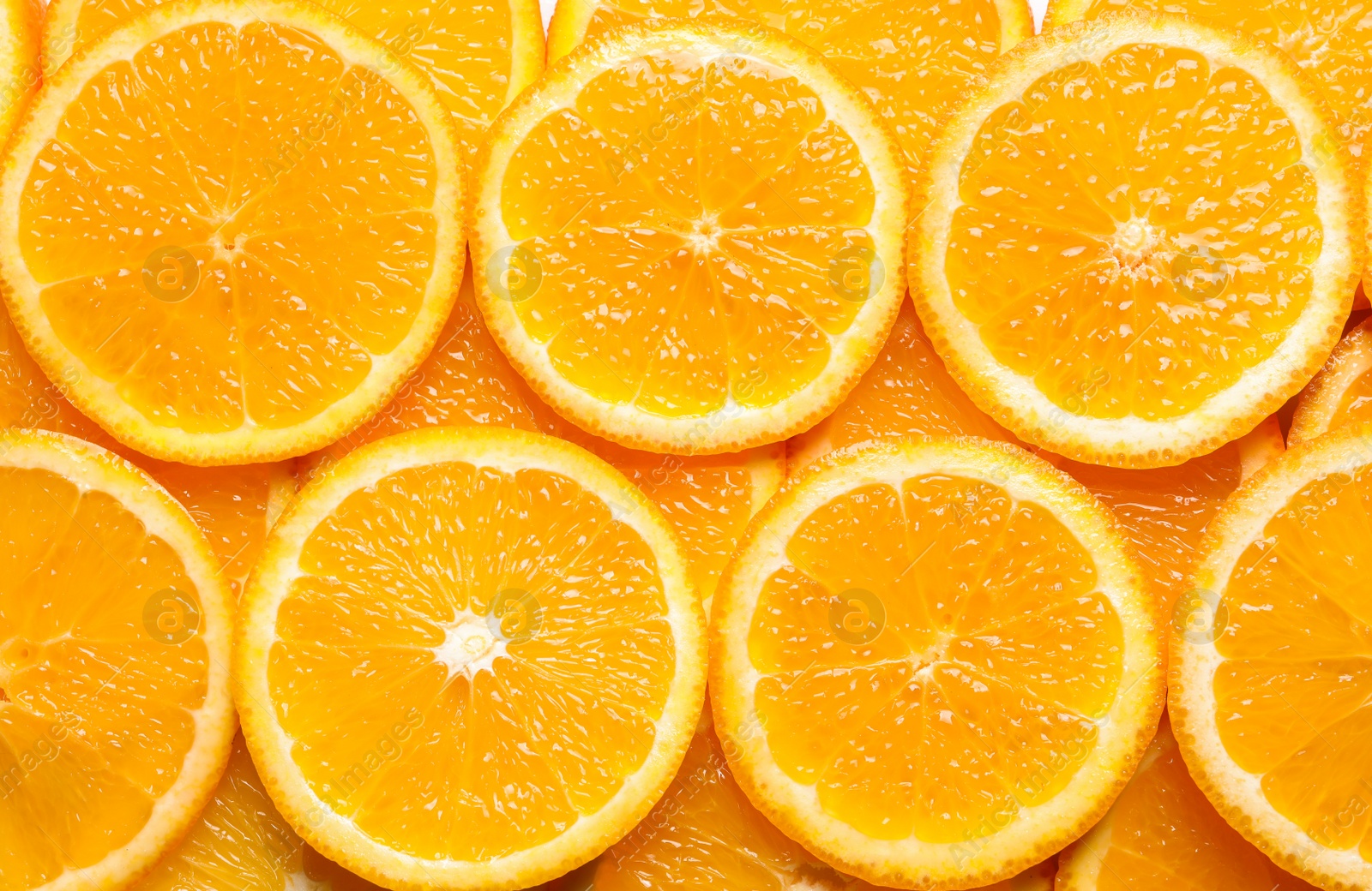 Photo of Juicy orange slices as background, top view. Citrus fruit