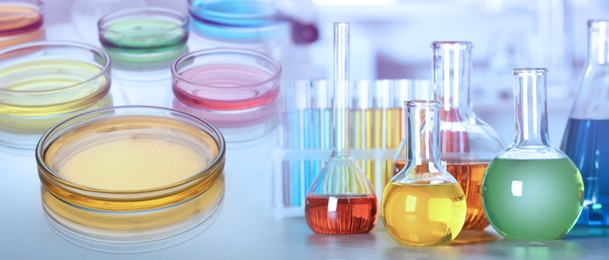 Image of Chemistry and chemical research. Collage of different laboratory glassware with colorful liquids . Banner design