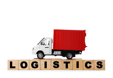 Toy truck and cubes with word LOGISTICS isolated on white. Wholesale concept
