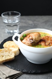 Tasty cooked rabbit meat with sauce served on grey table, closeup