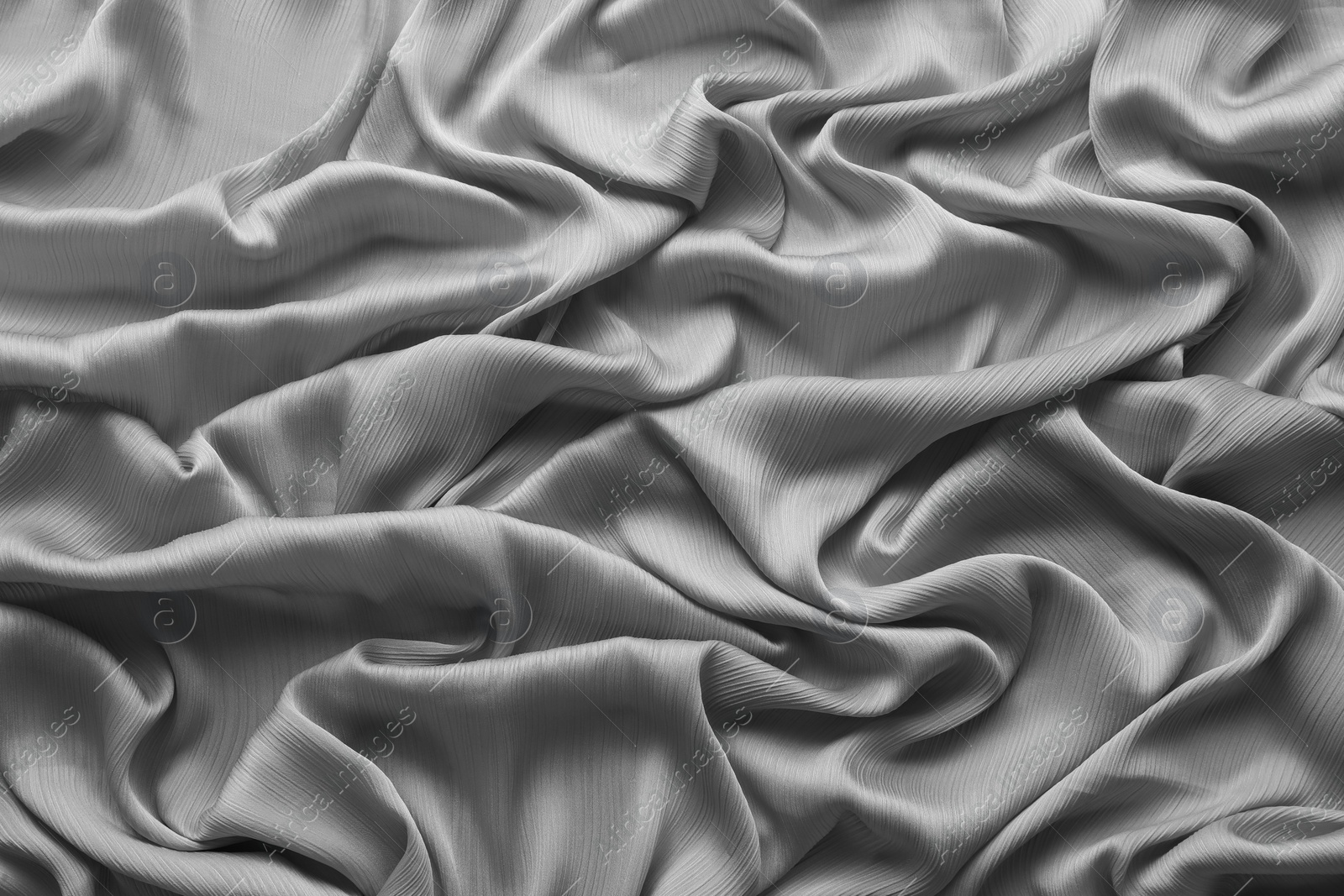 Photo of Beautiful grey tulle fabric as background, top view