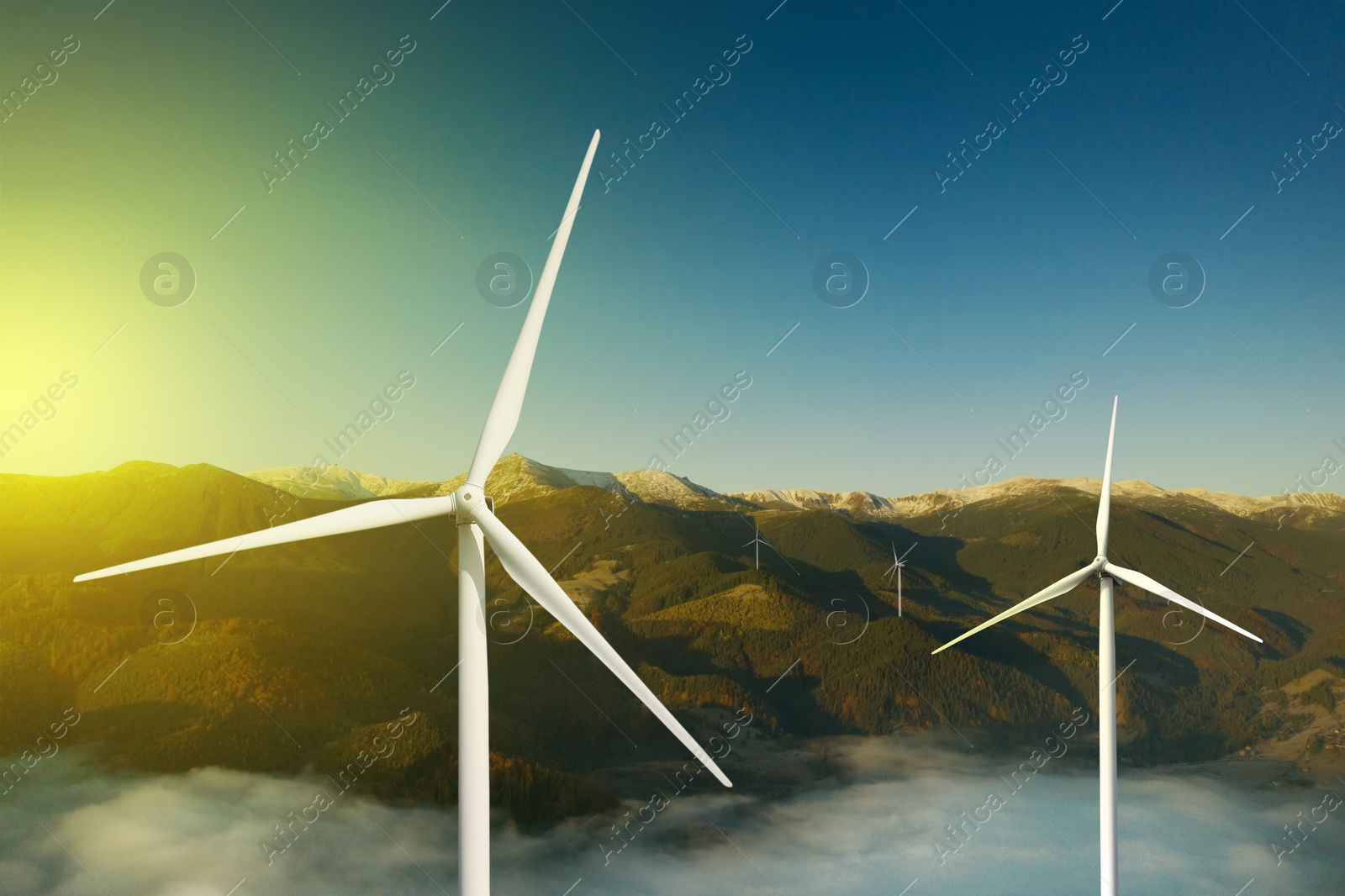 Image of Modern wind turbines in mountains. Alternative energy source