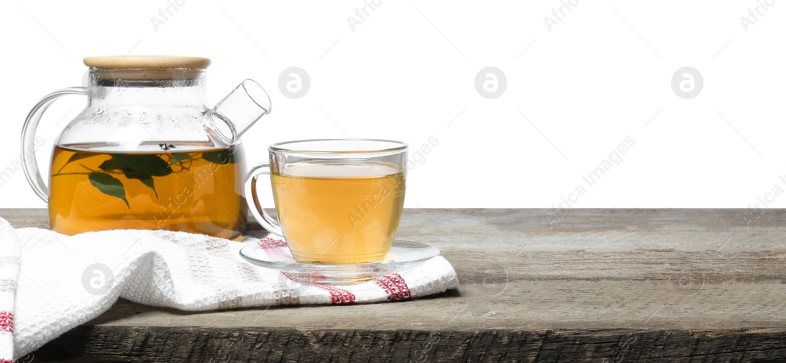 Photo of Refreshing green tea in cup and teapot on wooden table against white background