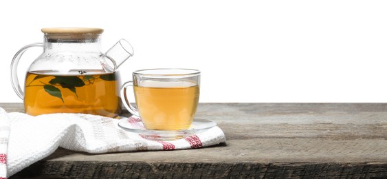 Refreshing green tea in cup and teapot on wooden table against white background