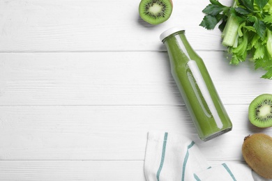 Photo of Flat lay composition with bottle of fresh celery juice on white wooden table, space for text