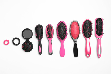 Composition with hair brushes on white background, top view