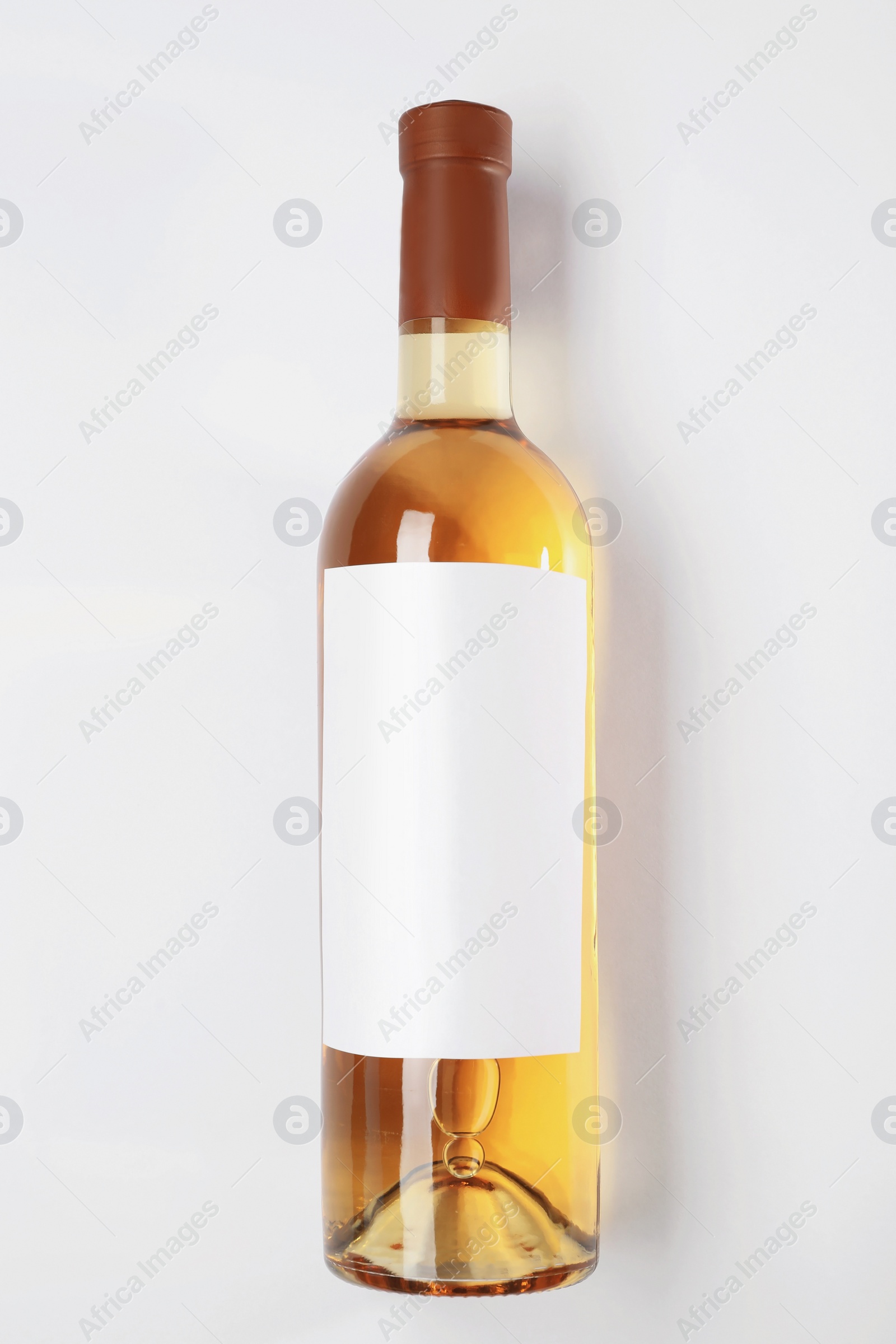 Photo of Bottle of delicious wine with blank label on white background