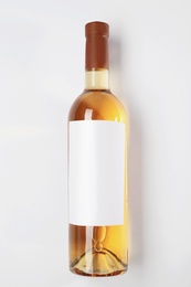 Bottle of delicious wine with blank label on white background