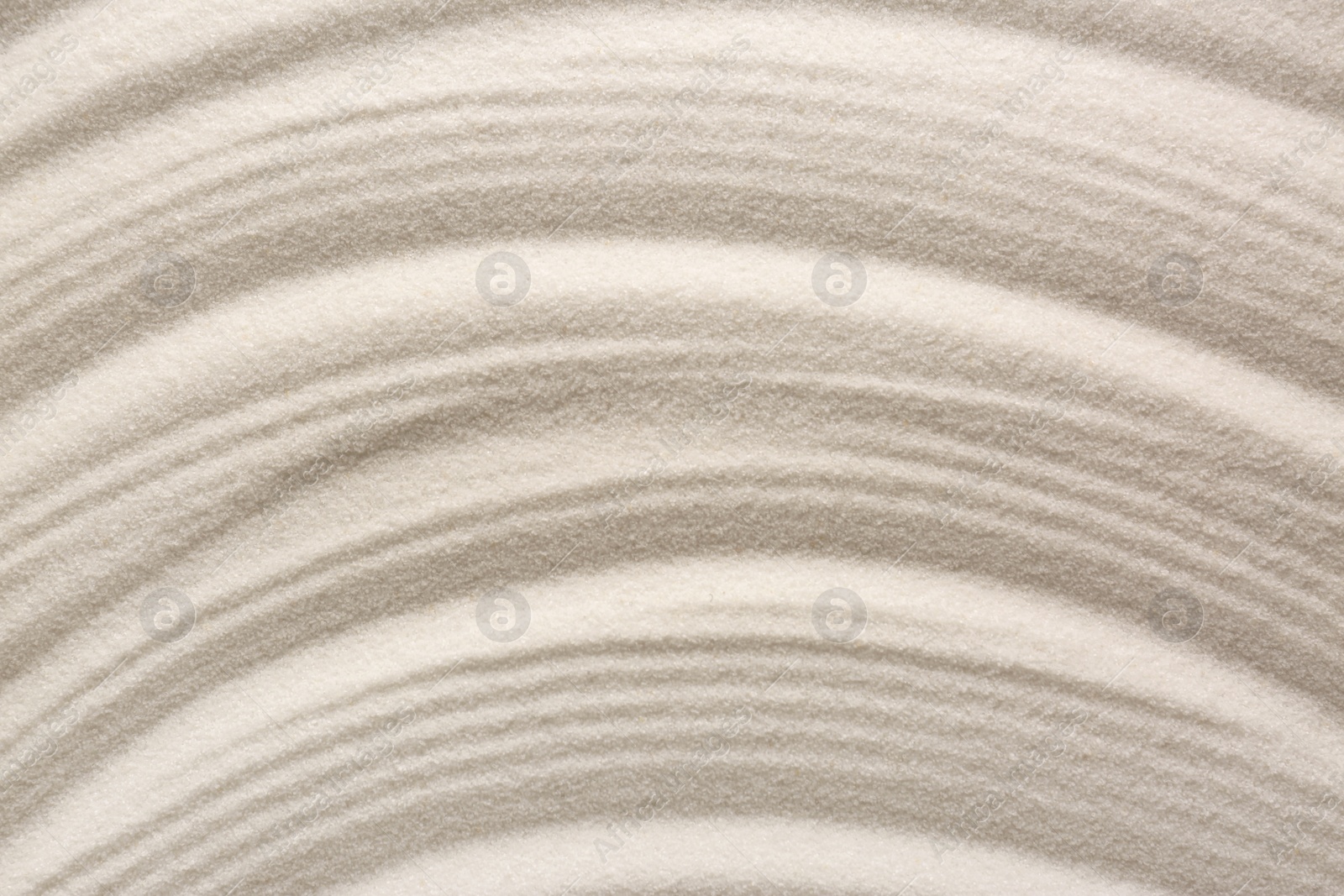 Photo of White sand with pattern as background, top view. Concept of zen and harmony