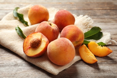 Photo of Fresh sweet peaches on wooden table. Natural fruit