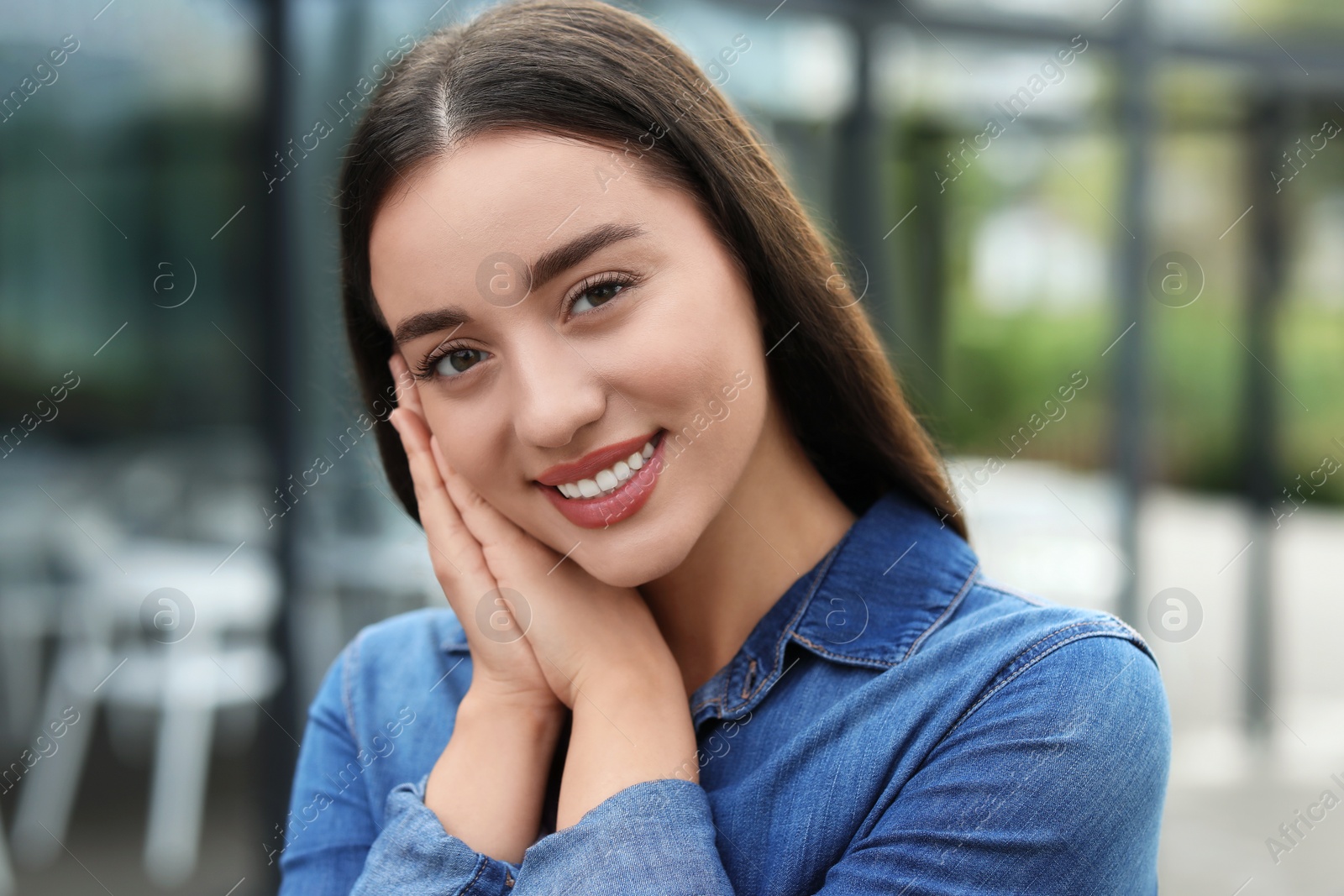 Photo of Portrait of beautiful woman outdoors. Attractive lady smiling and looking into camera