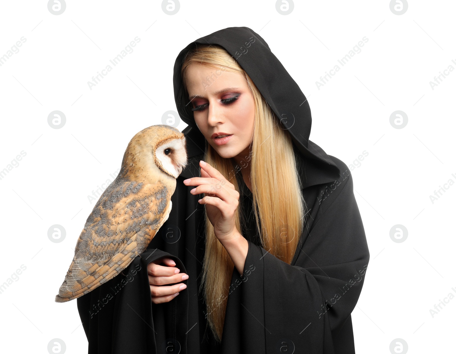 Photo of Witch in black mantle with owl isolated on white. Scary fantasy character