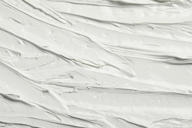 Photo of Texture of white oil paint as background, closeup