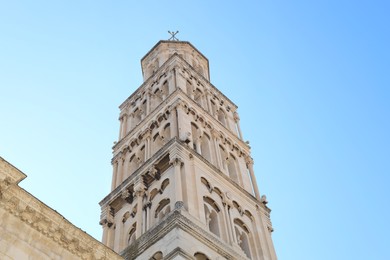 Photo of Beautiful old building against light blue sky, low angle view