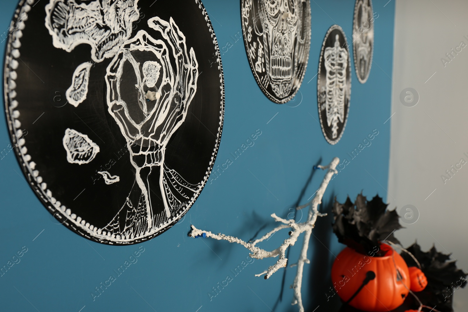 Photo of Different beautiful Halloween decorations on blue wall