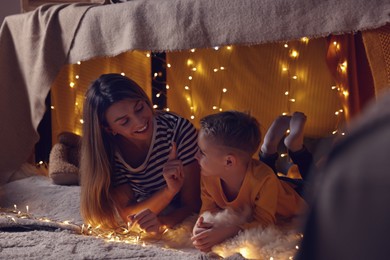 Mother and her son in play tent at home