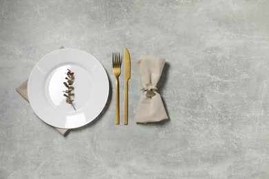 Photo of Stylish setting with elegant cutlery on grey table, flat lay. Space for text