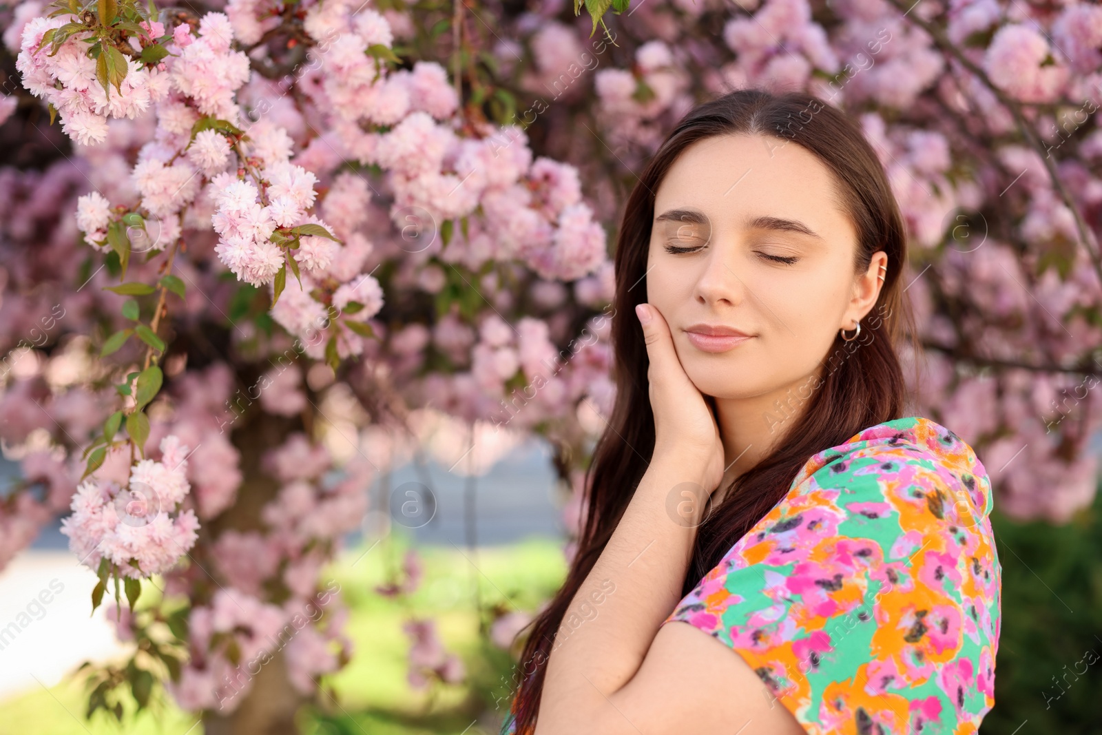 Photo of Beautiful woman near blossoming tree on spring day