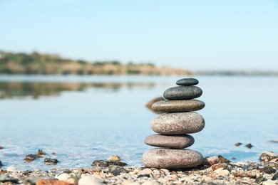 Photo of Stack of stones on beach, space for text. Harmony and balance concept