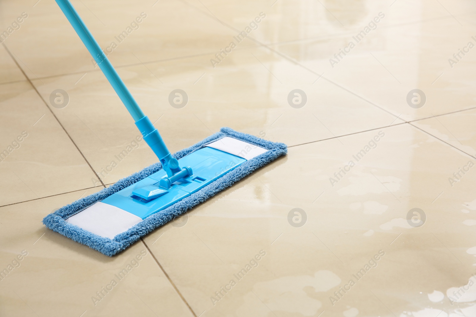 Photo of Washing of floor with mop, closeup. Space for text