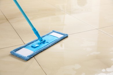 Photo of Washing of floor with mop, closeup. Space for text