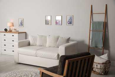 Photo of Modern living room interior with comfortable sofa and armchair