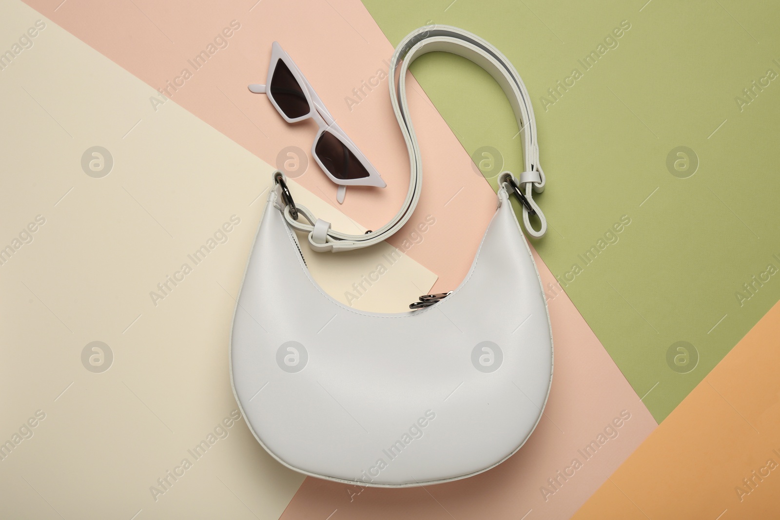 Photo of Stylish women's bag and sunglasses on color background, flat lay