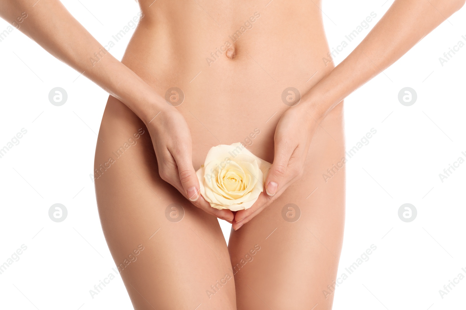 Photo of Woman with flower showing smooth skin after Brazilian bikini epilation on white background, closeup. Body care concept