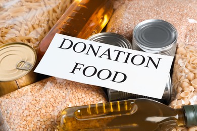 Photo of Card with words Donation Food on different products, closeup