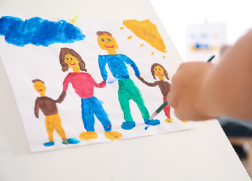 Photo of Little child painting family indoors, closeup view