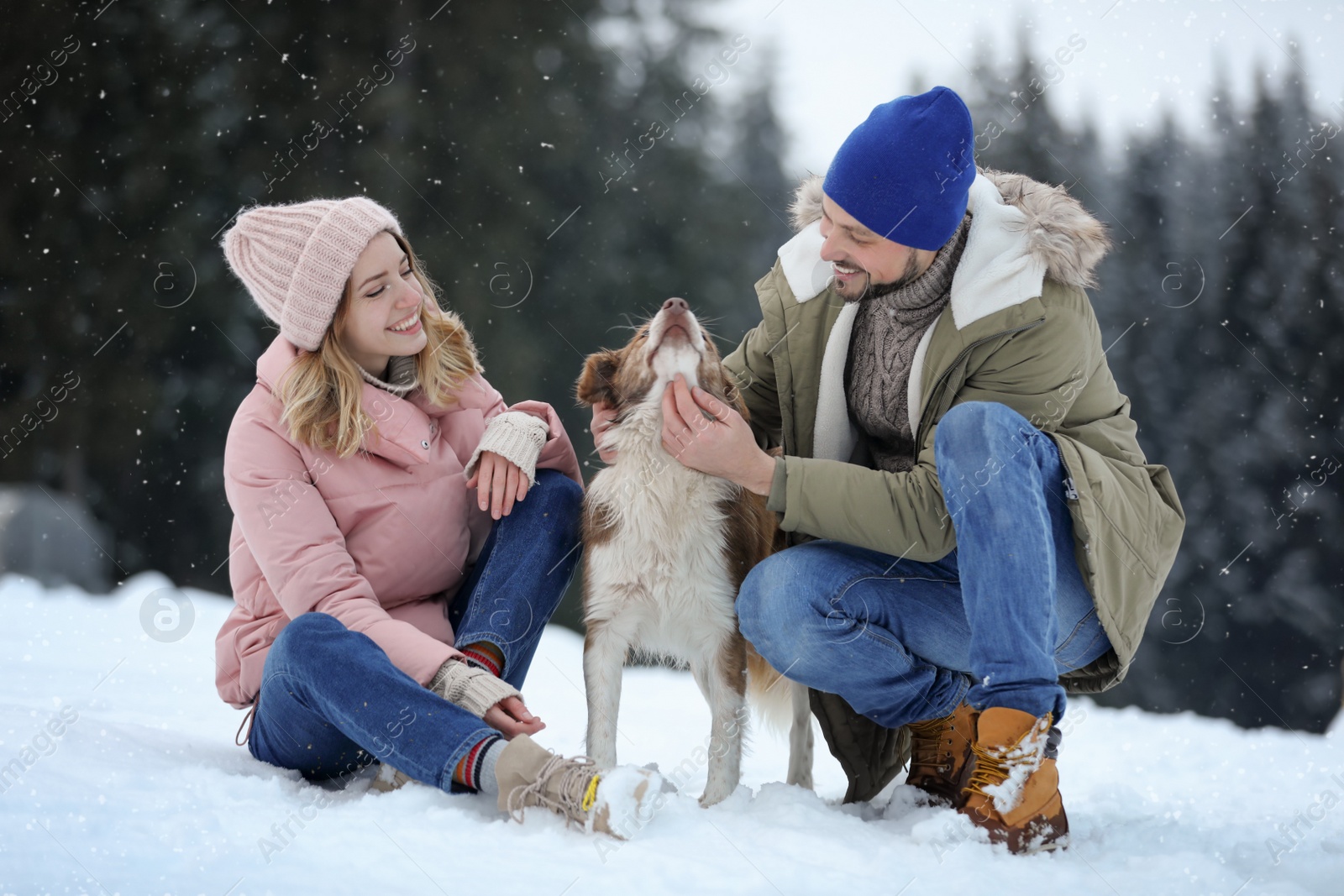 Photo of Cute couple with dog near forest. Winter vacation