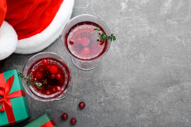 Photo of Delicious Christmas cocktail with liqueur on grey table, flat lay. Space for text