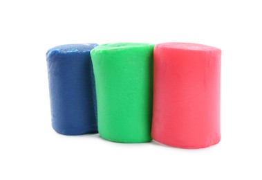 Photo of Different colorful play dough on white background