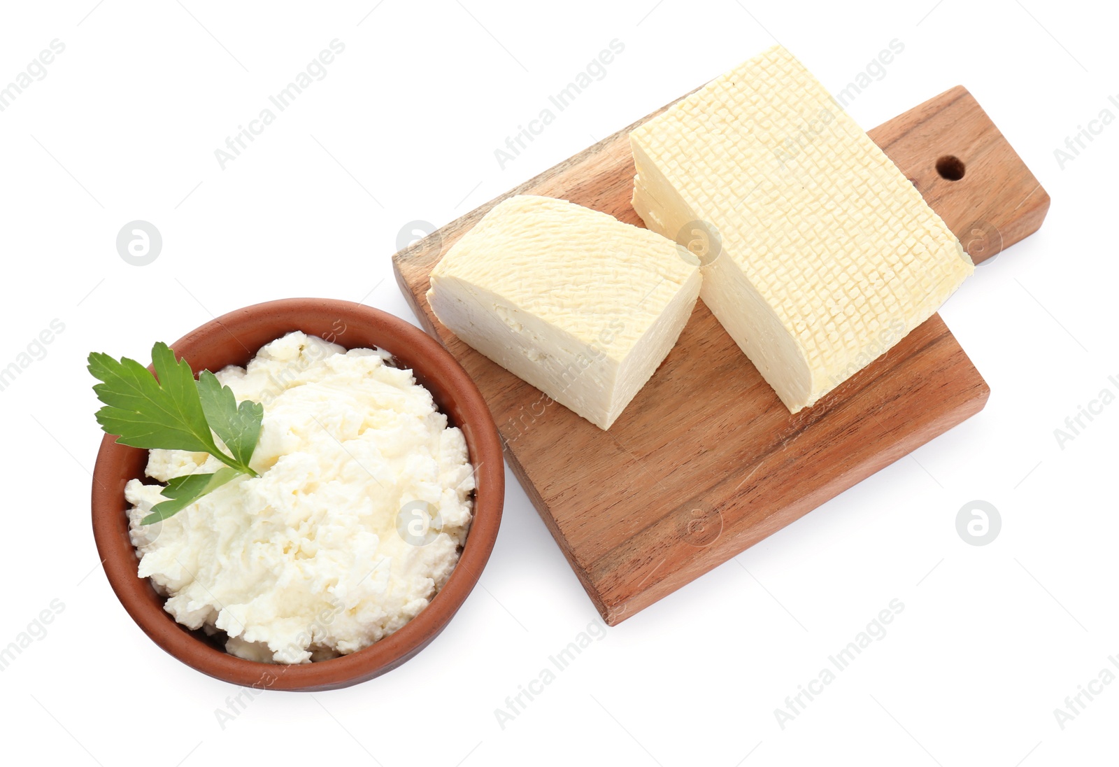 Photo of Different types of delicious tofu cheese with parsley on white background, top view