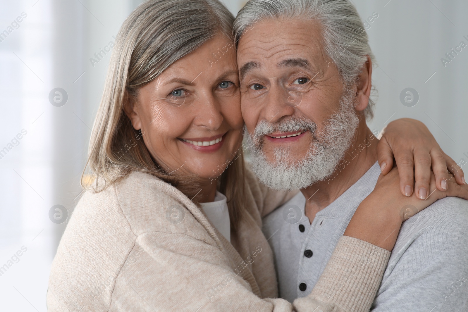 Photo of Portrait of affectionate senior couple at home