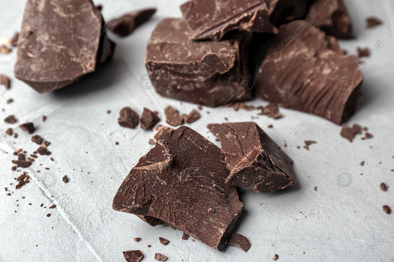 Photo of Delicious dark chocolate on grey background, closeup