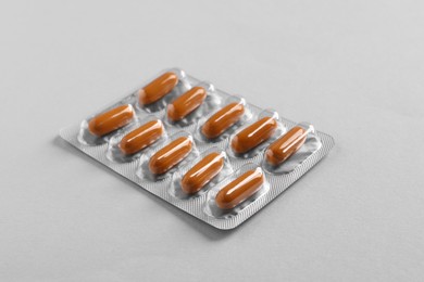 Photo of Blister of pills on white background. Medicinal treatment