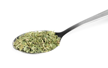 Spoon with dried parsley on white background