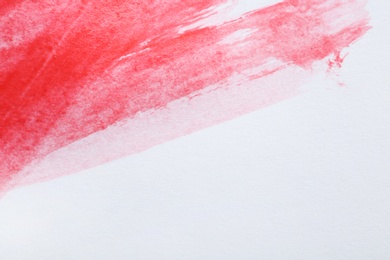 Photo of Abstract brushstroke of red paint isolated on white. Space for text