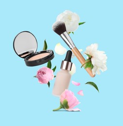 Spring flowers and makeup products in air on light blue background