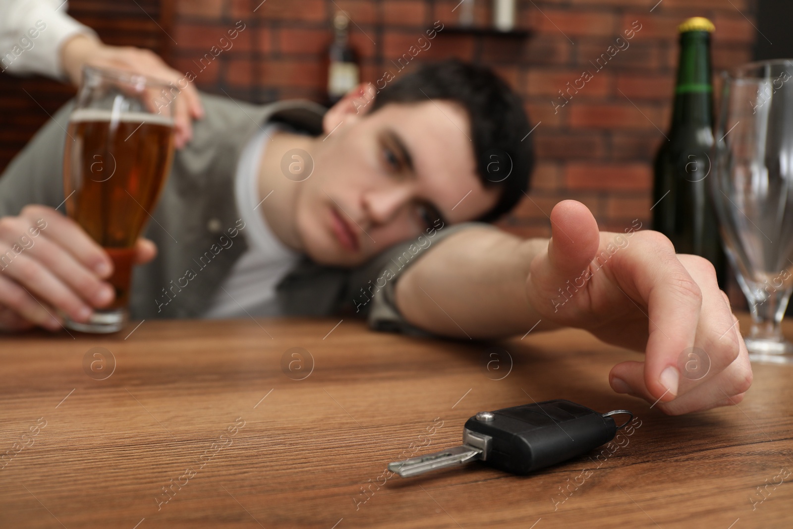 Photo of Woman stopping man from drunk driving, closeup. Don't drink and drive concept