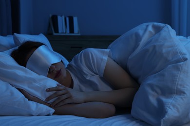 Photo of Woman with mask sleeping in bed at night