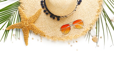 Photo of Flat lay composition with stylish hat and beach objects on white background